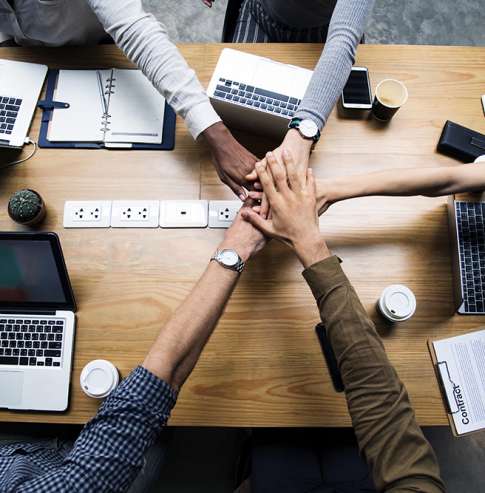 Team of business people stacking hands